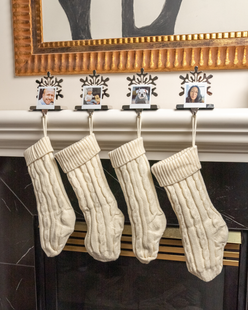 Christmas Stockings hanging on mantlepiece with instax™ prints