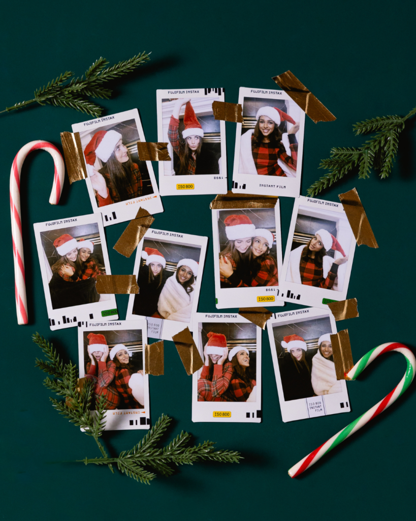 instax™ mini prints next to branches of christmas tree and candy canes