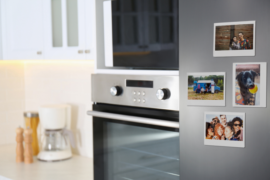 instax™ WIDE photo magnets stuck on a fridge