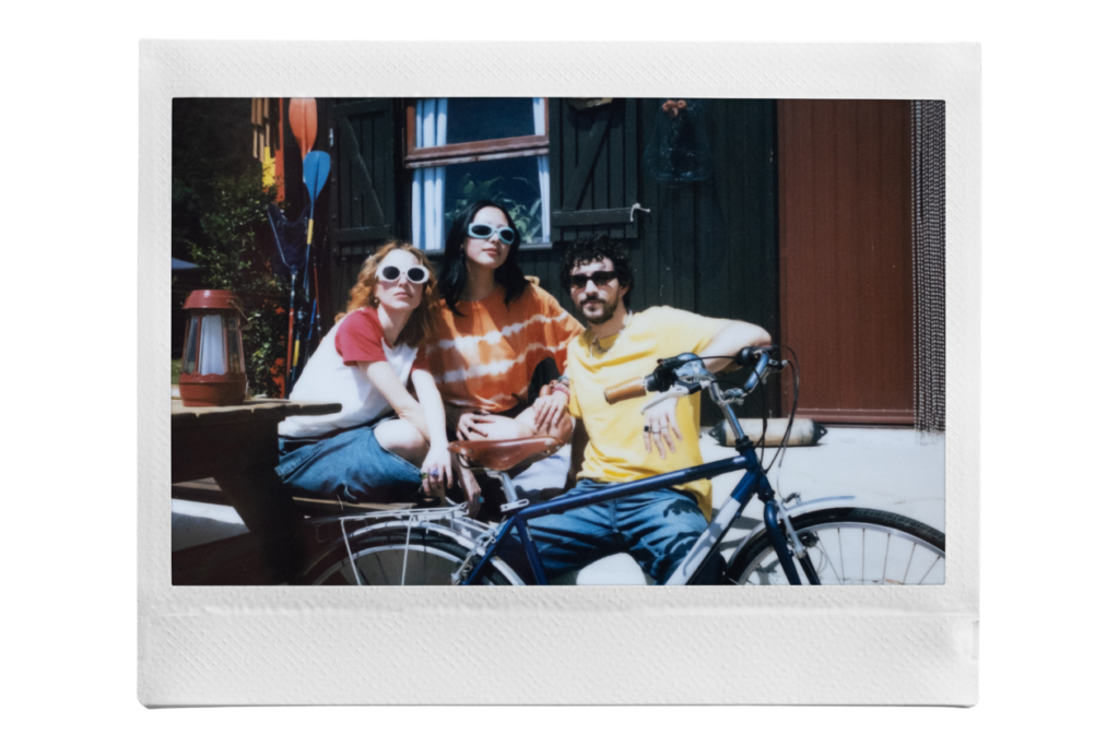 instax™ WIDE print of three friends wearing sunglasses and one is holding a bike