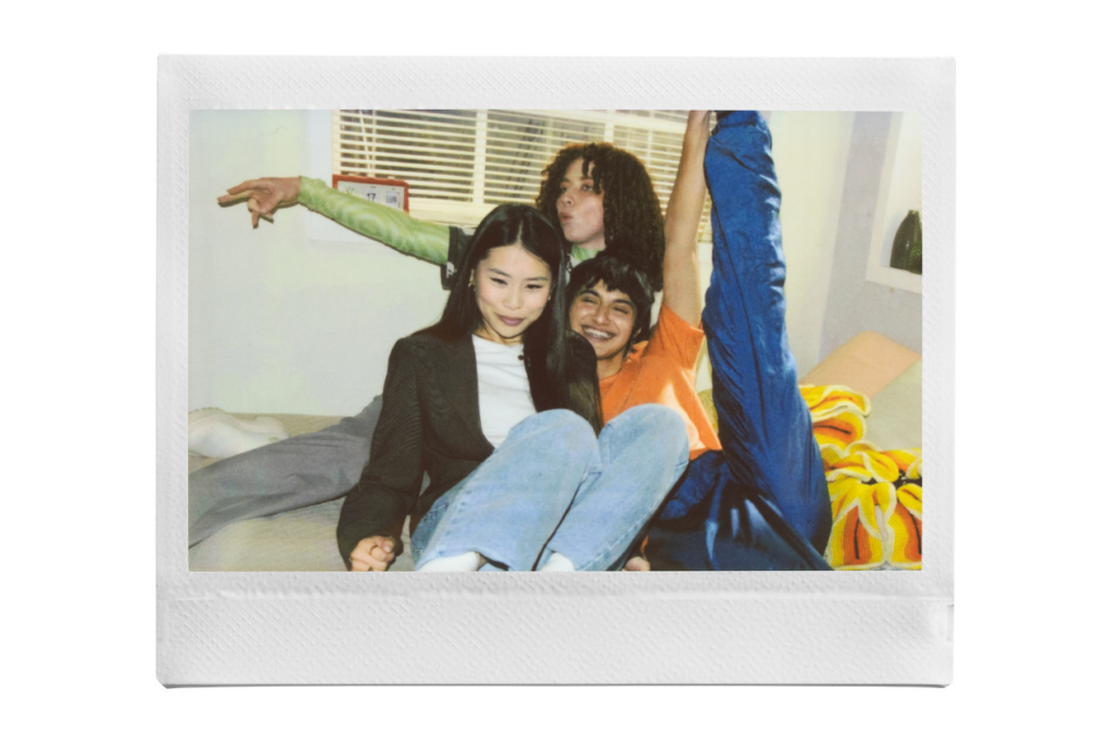 instax™ WIDE print of three friends posing on a bed